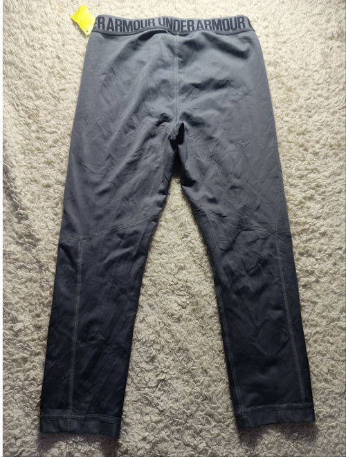 Dark gray athletic leggings laid flat on a beige carpet, with the waistband showing the brand name 'BARMENDES' and a small yellow price tag attached near the left hip.