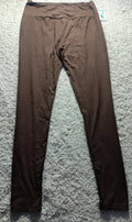 A pair of solid brown leggings laid flat on a textured gray carpet, with a small retail tag visible at the waistband.