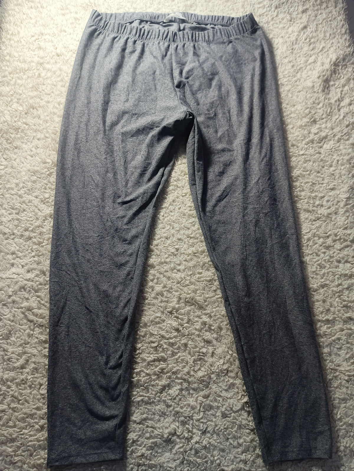 Dark gray lounge pants with an elastic waistband, laid flat on a textured gray carpet.