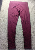 A pair of loose-fitting burgundy pants laid flat on a white textured carpet, photographed from above. The photo has a camera metadata overlay at the bottom.