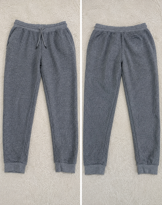 Two views of heather gray jogger pants laid flat on a light textured background, labeled POVA 6 Neo with measurements 23mm and fabric code 1/1.4 1/25s ISO722 / ISO760.