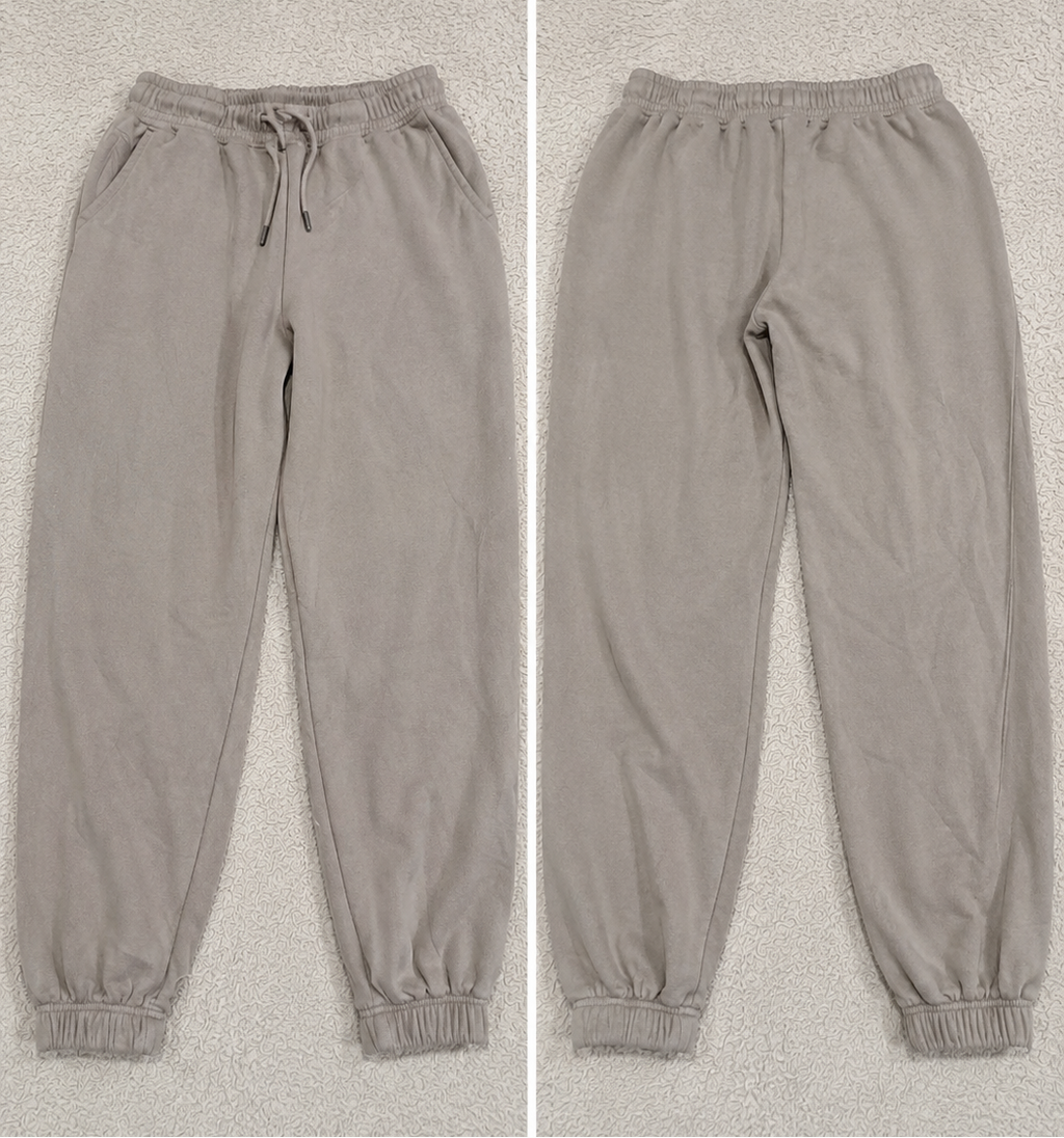 A pair of jogger-style pants shown in a side-by-side split view, labeled 'POVA 6 Neo' with size and color text below each view. The pants are a light warm gray or taupe tone with an elastic waistband, drawstring, side pockets, and elastic cuffs.