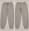 A pair of jogger-style pants shown in a side-by-side split view, labeled 'POVA 6 Neo' with size and color text below each view. The pants are a light warm gray or taupe tone with an elastic waistband, drawstring, side pockets, and elastic cuffs.